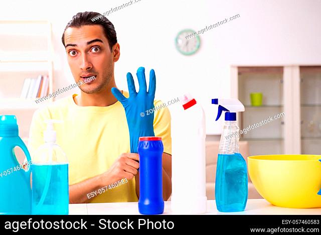 Young contractor doing housework at home