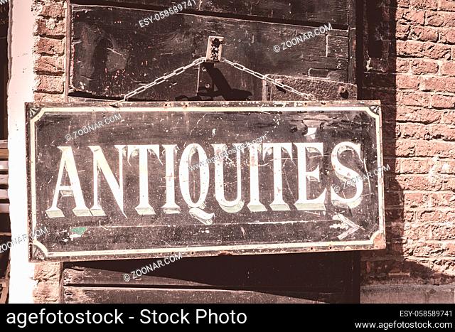 Antiques sign on an old brick building