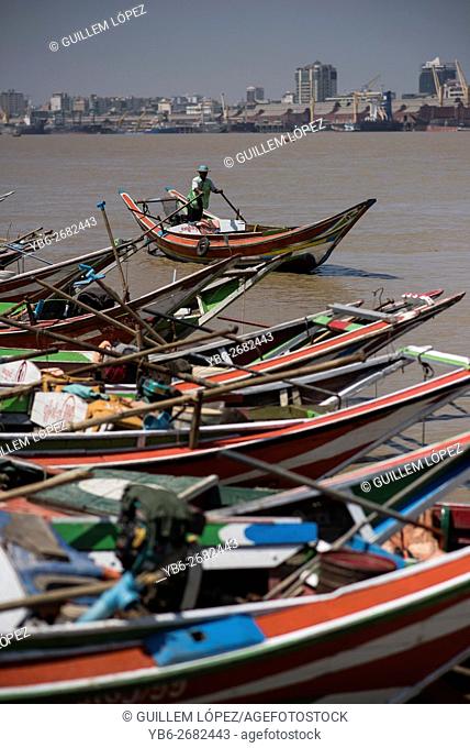 Long tail boats moored at the Irrawaddy River shore in Dala, Yangon, Myanmar