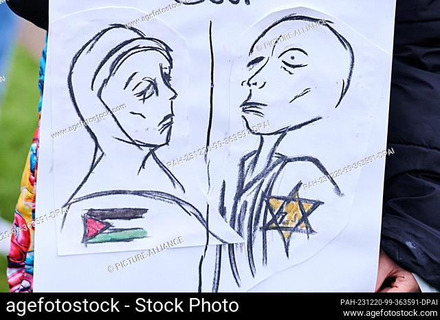 20 December 2023, Berlin: One poster shows a grieving woman with a Palestinian flag on one side and a ""Holocaust survivor Jew"" (quote from the demonstrator)...