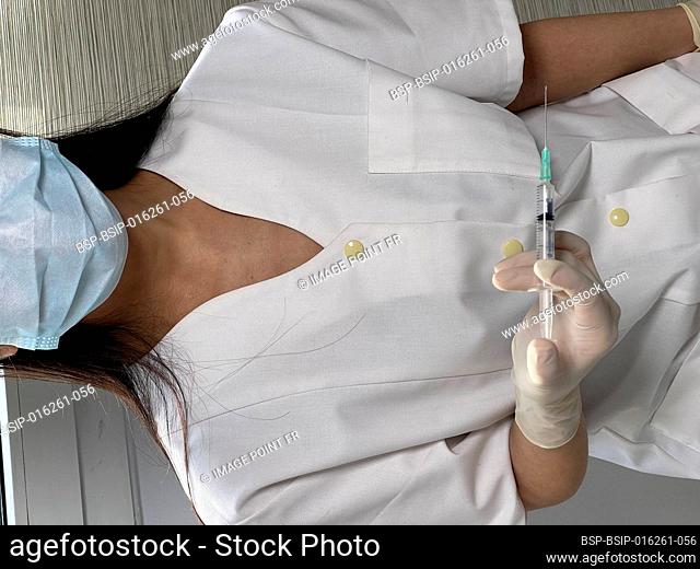 Nurse holding syringe with covid-19 vaccine