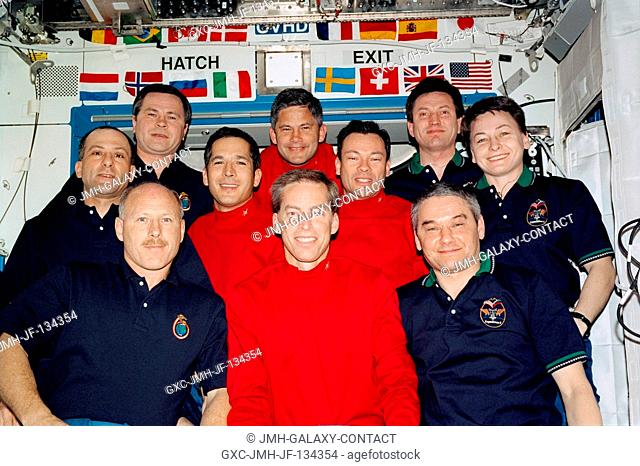 The STS-113 (red shirts), Expedition Five (right) and Expedition Six crewmembers (left) gathered for a group photo in the Destiny laboratory on the...