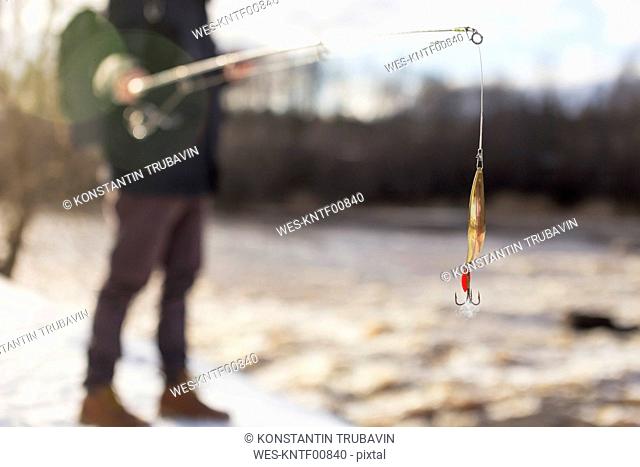 Man fishing in winter