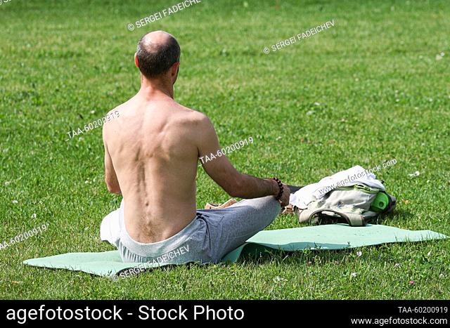 RUSSIA, MOSCOW - JULY 2, 2023: A man meditates during Yoga Day Russia 2023, a yoga festival marking the International Day of Yoga, in Tsaritsyno Park