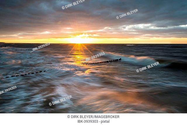 Breakwaters or groynes, sunset, storm clouds, breaking wave, evening light, Baltic Sea, Fischland-Darß-Zingst peninsula, Mecklenburg-Western Pomerania, Germany
