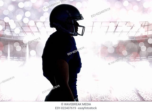 Composite image of side view of silhouette american football player standing