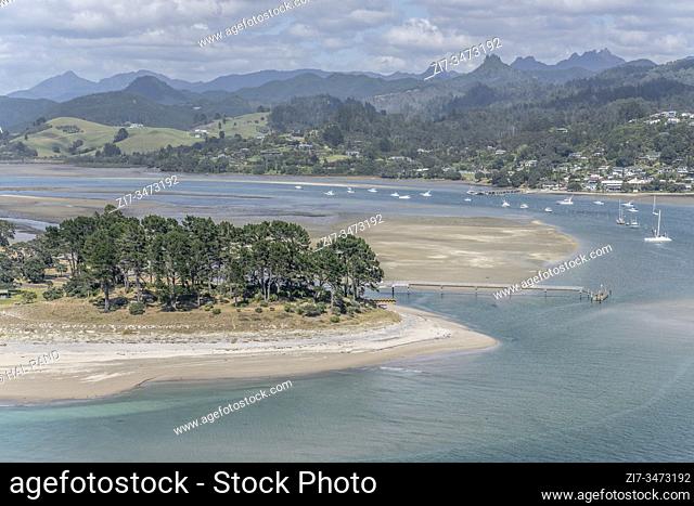 aeral landscape of Royal Billy sand cape and Pauanui wharf at Tairua bay, shot at low tide time in bright late spring light from Paku peak, Coromandel