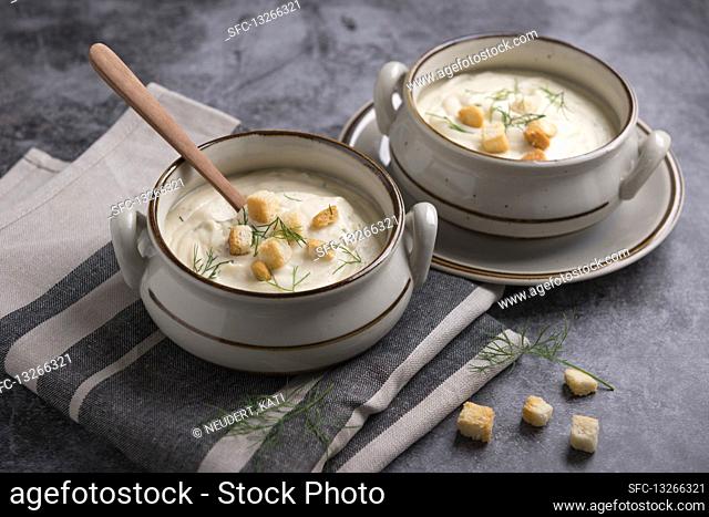 Vegan parsnip cream soup with croutons and dill
