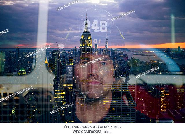 Portrait of confident firefighter with the reflected skyline of New York City, United States