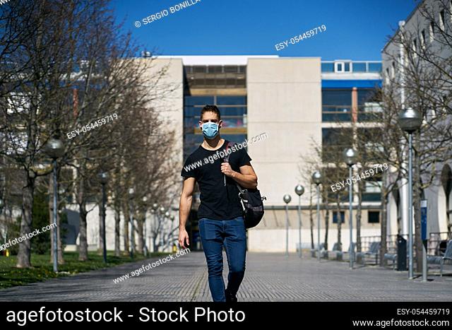 Caucasian male in medical masks walking the streets. The concept of Coronavirus