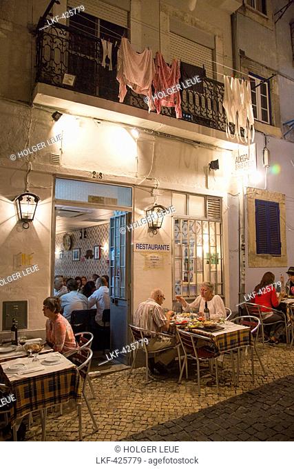 People sitting outdoors and enjoying dinner at Adega do Ribatejo in Bairro Alto district, Lisbon, Lisboa, Portugal