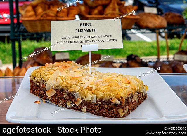 A French label is seen stuck in a freshly baked cake named Queen Elizabeth with ingredients. Homebaked foods at a local farmer's market