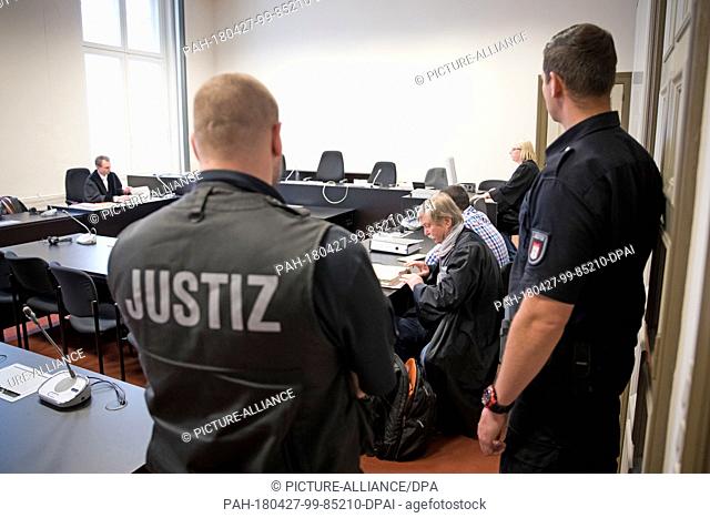 27 April 2018, Germany, Hamburg: Lawyer Wilfired Behrendt (C) and his slient sitting in court before the trial begins. A trial began in friday in front of the...