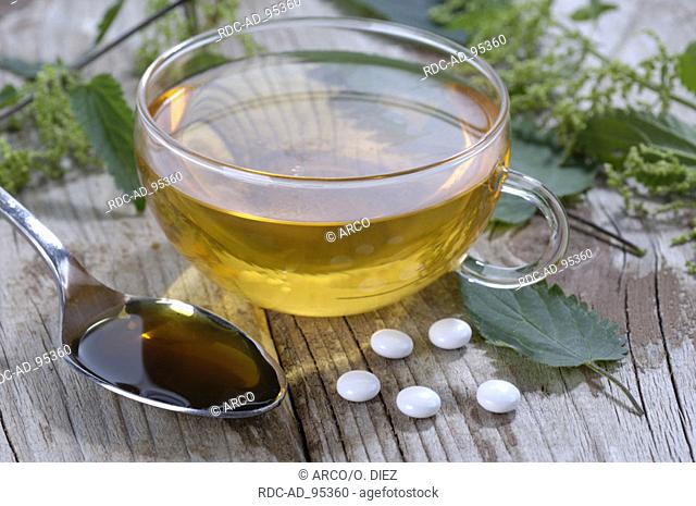 Cup of tea Nettle juice and Nettle pills Urtica dioica
