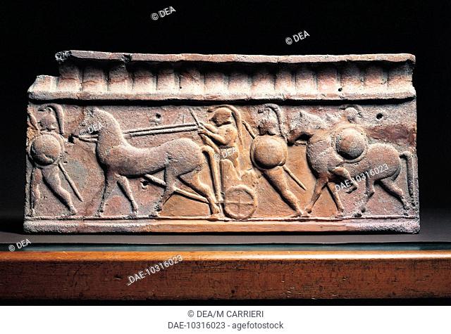 Etruscan civilization, 6th century b.C. Clay slab depicting a warrior in typical Greek armour getting on a chariot. From Arce di Veio Temple  Rome