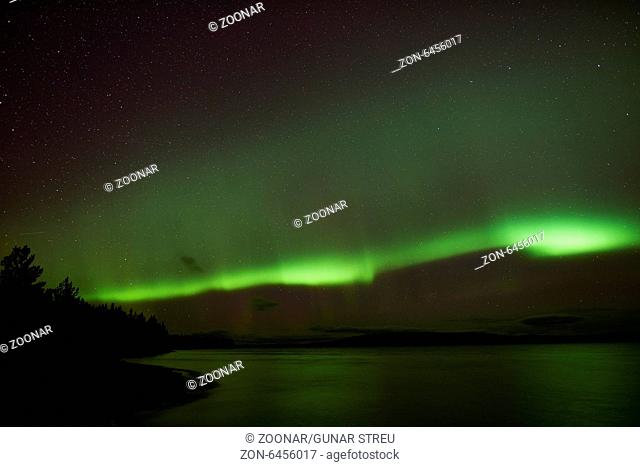 Northern lights above a lake, Lapland, Sweden