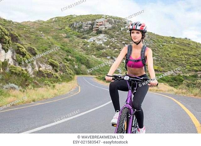 Athletic woman mountain biking