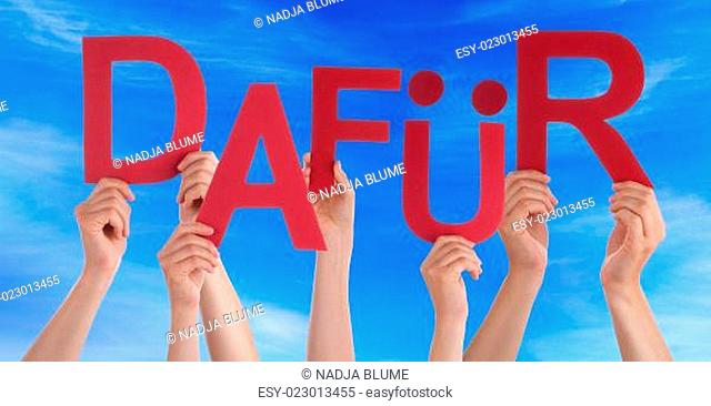 People Holding German Word Dafuer Means For It Blue Sky