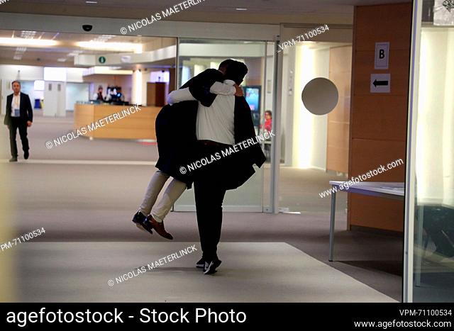 Ibrahim Farisi embraces his lawyer after receiving a not-guilty verdict at a session to read the verdict of the trial of the terrorist attacks of March 22, 2016