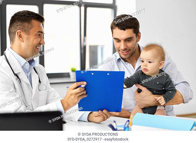 father with baby and doctor at clinic