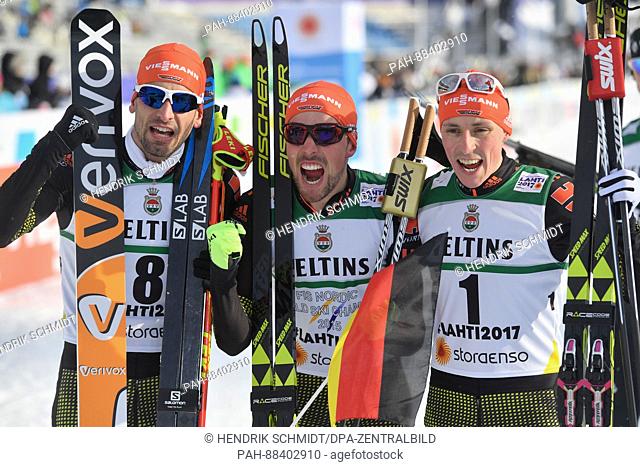 Johannes Rydzek (c, 1st Place), Eric Frenzel (r, 2nd Place) and Bjoern Kircheisen (3rd Place), all from Germany, celebrate after the single combination event...