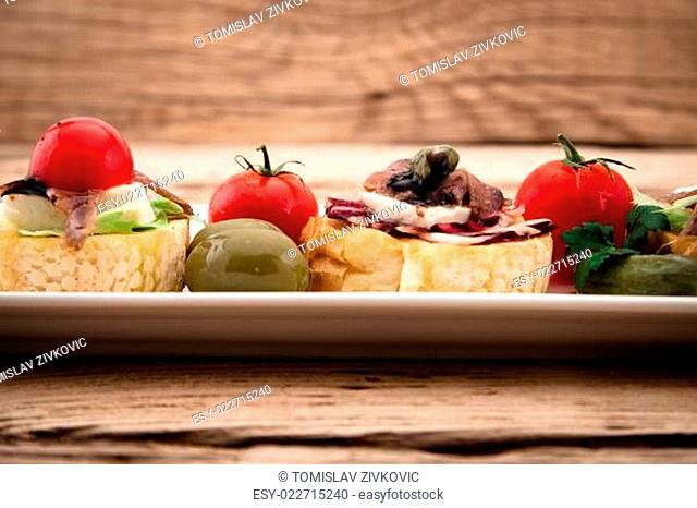 Crostini vith mozzarella cheese anchowy and tomato