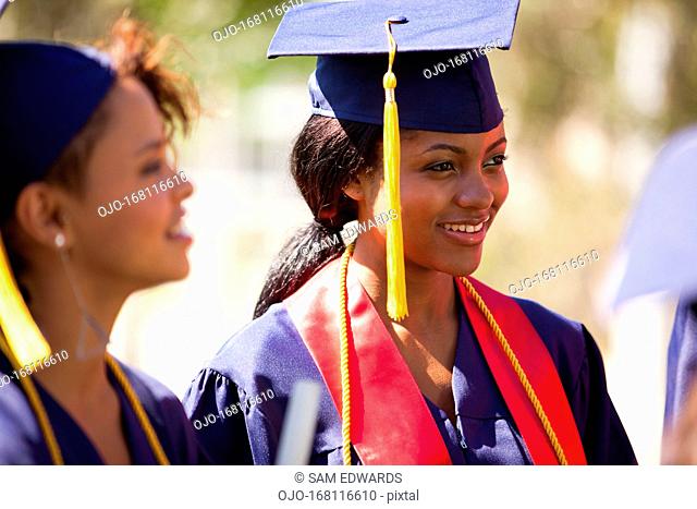 Graduates smiling in cap and gown