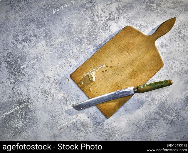 Wooden board with palette knife on a concrete background