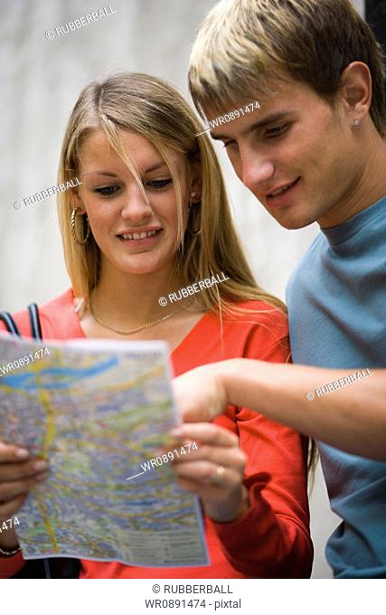 Close-up of a teenage couple looking at a map