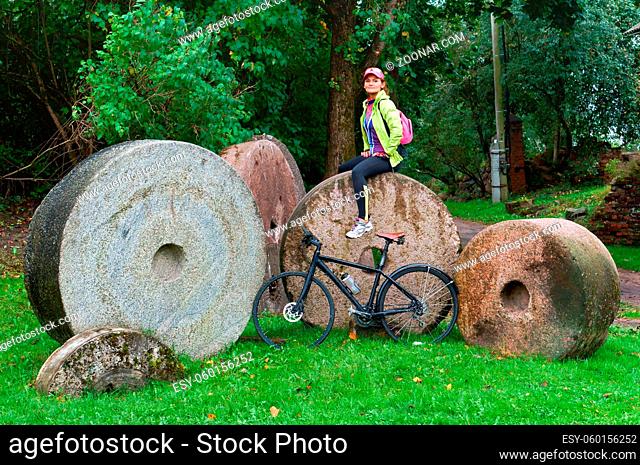 round millstones, old stone millstones for his mill, Biking