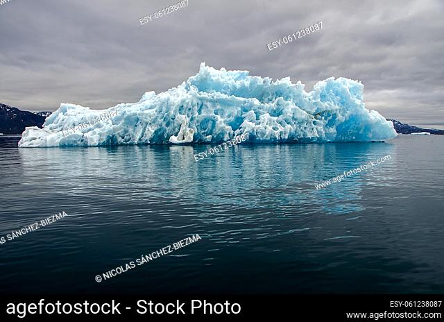 Bluish iceberg in a cloudy day