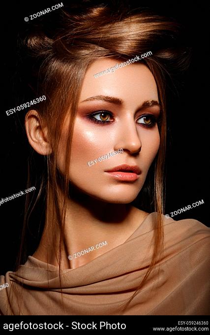 beautiful young woman with smoky eye make up. beauty portrait on black background