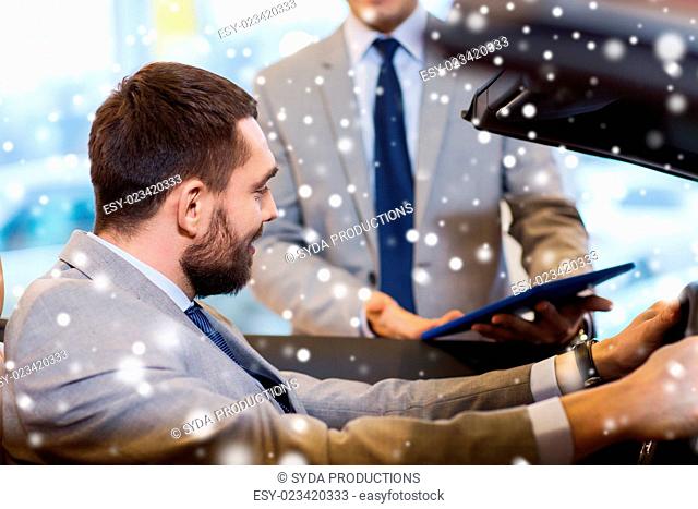 auto business, car sale, consumerism and people concept - happy man with car dealer in auto show or salon over snow effect