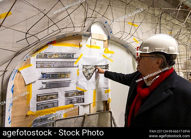 24 November 2023, Baden-Württemberg, Rust: Roland Mack, owner of Europa-Park, shows the plans for the ""Alpen-Express"" roller coaster at the construction site