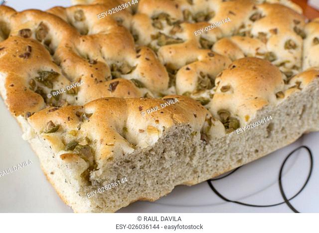 The focaccia is a traditional loaf - bread from the Italian cuisine and this is closely related to the pizza. in this picture you can see the texture and the...