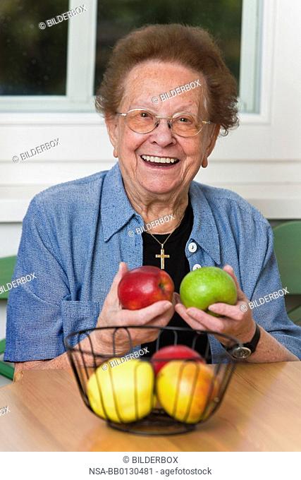 Old woman with apple for the daily Vitmaine