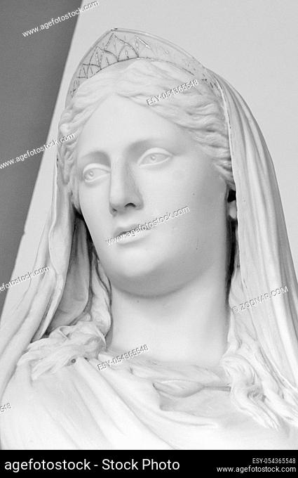 White marble head of young woman. Statue of a woman in the antique style. Ancient sculpture of lady face