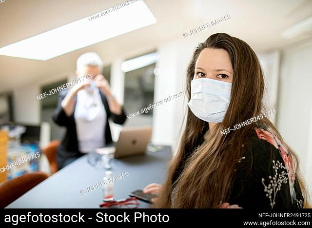 Woman in office wearing face mask