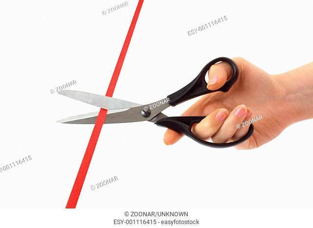 Hand with scissors and ribbon