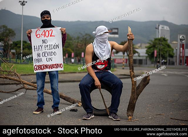 Demonstrators covering their faces hold a sign that reads ""6402, no forgiveness, we wont forget an abusive government"" as demonstrators gather during the...