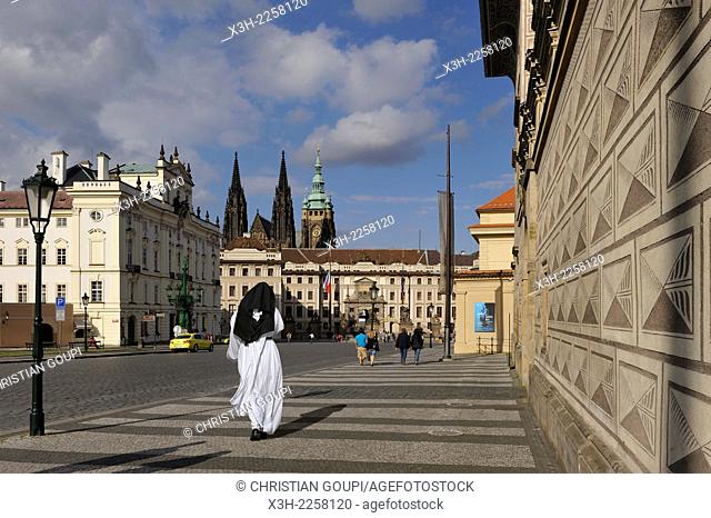 nun beside the Schwarzenberg Palace housing a rich collection of Baroque paintings and sculptures, Hradcanske Square, Hradcany district, Prague, Czech Republic