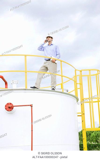 Engineer inspecting industrial storage tank