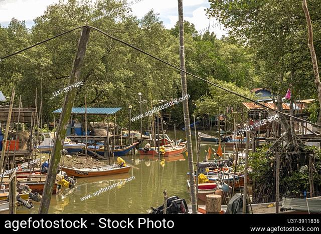 A Malay houses and small fishing boats at Buntal Fishing Village, Sarawak, East Malaysia, Borneo