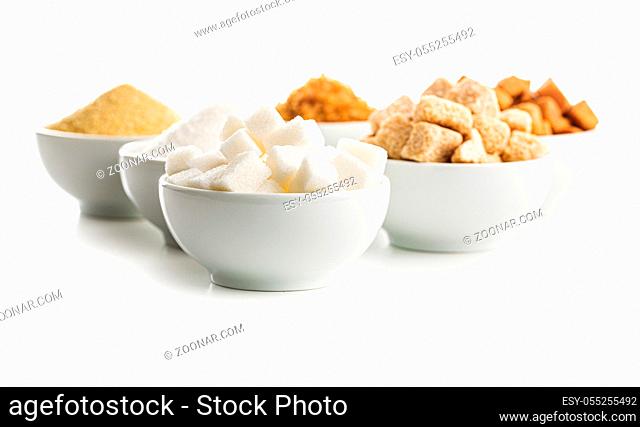 Brown and white sugar in bowls isolated on white background