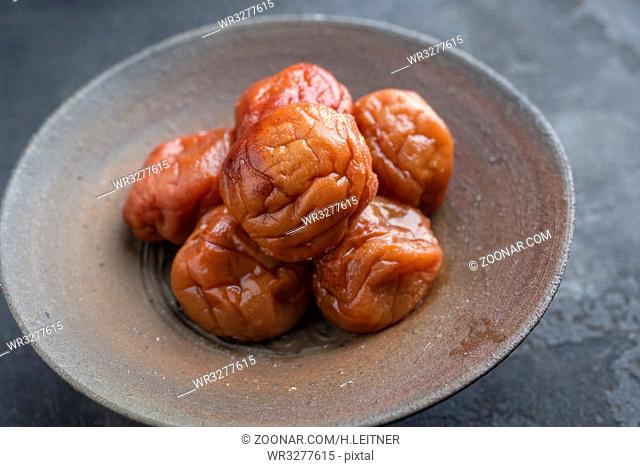 Traditional Japanese Umeboshi as close-up in a bowl