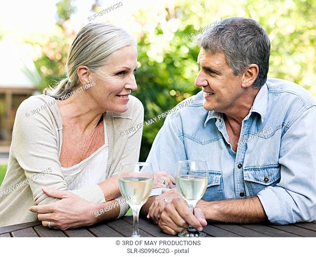 Couple with wine in garden