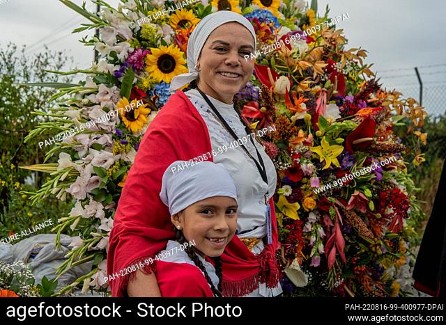 15 August 2022, Colombia, Santa Elena Antioquia: Mother and daughter, dressed in traditional costumes of the region, prepare for the day of the Silletero parade...