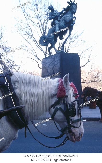 New York Street Scene near Central Park, showing an equestrian statue (of Jose Marti, Cuban national hero, by Anna Hyatt Huntington) with real horses in the...