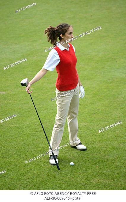 Female golfer contemplating her shot