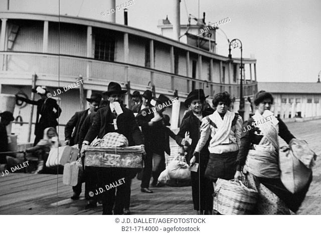 History, USA, New York. Immigrants arriving from Europe at the Ellis Island, around 1900